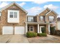 Two story brick home with a two car garage and manicured lawn at 2756 Palmview Sw Ct, Atlanta, GA 30331