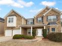 Two story brick home with a two car garage and manicured lawn at 2756 Palmview Sw Ct, Atlanta, GA 30331