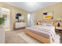 Virtually staged bedroom with light wood furniture and carpet at 1089 Brittwood Pl, Norcross, GA 30093