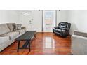 Comfortable living room with hardwood floors, sofa, and an accent chair at 1625 Conley Rd # 270, Conley, GA 30288