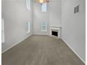 Large living room featuring high ceilings and a corner fireplace at 7085 Magnolia Ln, Fairburn, GA 30213