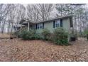 Ranch-style home with a yard covered in leaves at 180 Sears Cir, Covington, GA 30016