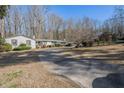 House exterior showcasing a long driveway and surrounding landscape at 75 Azalea Trl, Carrollton, GA 30116