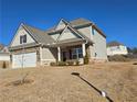 Two-story house with stone accents and a two-car garage at 1455 Weeping Tree Cir, Auburn, GA 30011