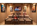 Cozy home theater with plush seating, movie posters, and a large screen for entertainment at 3336 Ferncliff Ne Pl, Atlanta, GA 30324