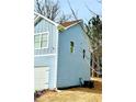 A two-story home featuring light blue siding, white trim, and an attached two-car garage at 4405 Belcamp Rd, Fairburn, GA 30213