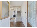 Bright entryway with hardwood floors and staircase at 8785 Seneca Rd, Palmetto, GA 30268