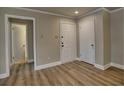 A bright entryway featuring wood-look flooring and white trim at 3412 Lake Pointe Cir, Roswell, GA 30075