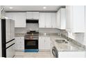 Beautiful kitchen featuring stainless steel appliances, granite countertops, and ample white cabinetry for storage at 1421 Eason St, Atlanta, GA 30314