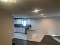 Modern kitchen with white cabinets, granite countertops, and a center island at 1421 Eason St, Atlanta, GA 30314