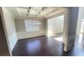 Open-concept living room featuring coffered ceilings, wainscoting and hardwood floors at 2536 Dayview Ln, Atlanta, GA 30331