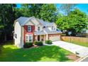 A charming two-story home with a well-maintained lawn, brick facade, and basketball hoop on the driveway at 2548 Brentmoor Ct, Suwanee, GA 30024