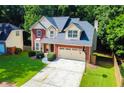 Beautiful two-story home with a well-manicured lawn, brick facade, and two car garage at 2548 Brentmoor Ct, Suwanee, GA 30024