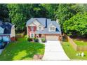 Beautiful two-story home with a well-manicured lawn, brick facade, and two car garage at 2548 Brentmoor Ct, Suwanee, GA 30024