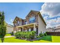 A two-story brick and siding home with a manicured lawn, covered entryway and side yard at 8051 Nolan Trl, Snellville, GA 30039