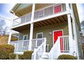 Two-story house with gray siding, white railings, and a red front door at 2650 Batavia St, East Point, GA 30344