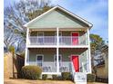 Two-story house with gray siding, white railings, and a red front door at 2650 Batavia St, East Point, GA 30344