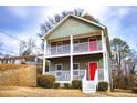 Two-story house with gray siding, white railings, and a red front door at 2650 Batavia St, East Point, GA 30344