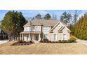 Charming two-story brick home with a covered porch and beautifully landscaped front yard at 313 Young James Cir, Stockbridge, GA 30281