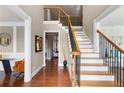 Elegant foyer featuring hardwood floors, a staircase with black iron spindles, and decorative molding at 313 Young James Cir, Stockbridge, GA 30281