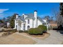 Stunning white home featuring manicured landscaping and architectural details at 4011 Charrwood Trce, Marietta, GA 30062