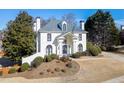 Beautiful home with manicured lawn, mature trees, and a circular driveway at 4011 Charrwood Trce, Marietta, GA 30062