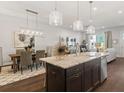 Modern kitchen with island, stainless steel appliances, and ample counter space at 405 Nettle Ct, Woodstock, GA 30188