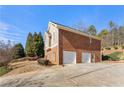 Three-car brick garage with a long driveway at 2270 Washington Dr, Douglasville, GA 30135