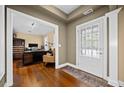 Inviting home foyer featuring a glass front door, hardwood floors, and a view into the office at 320 Jessica Way, Canton, GA 30114