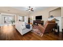 Comfortable living room featuring hardwood floors, a fireplace, and a cozy seating area at 320 Jessica Way, Canton, GA 30114