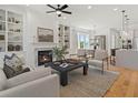 Spacious living room with a fireplace, built-in shelving, and hardwood floors at 401 Nettle Ct, Woodstock, GA 30188