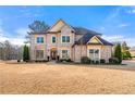 Charming two-story brick home with well-maintained landscaping and a welcoming entrance at 5269 Heron Bay Blvd, Locust Grove, GA 30248