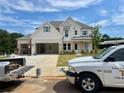 Two-story home with a spacious three-car garage, lovely brickwork, with a truck and work supplies nearby at 679 Crest Line Trl, Powder Springs, GA 30127