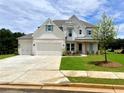 Beautiful new construction home featuring a brick facade, well-manicured lawn, and three-car garage at 679 Crest Line Trl, Powder Springs, GA 30127