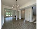 Spacious living room with hardwood floors, fireplace, and staircase leading to the second floor at 679 Crest Line Trl, Powder Springs, GA 30127