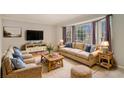 Spacious living room featuring bay windows, neutral carpeting, and ample natural light at 1519 Carnaby Ct, Dunwoody, GA 30338