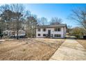 Two story house with driveway and mature trees at 942 Azalea Cir, Marietta, GA 30062