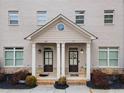 Two-unit townhome building with a shared front porch and landscaping at 1208 Stone Castle Cir # 3, Smyrna, GA 30080
