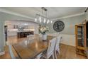Light and airy dining room, open to kitchen, with wood floors and trim at 202 Heights Pl, Canton, GA 30114