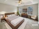 Virtually staged main bedroom with a large bed and ample natural light at 7045 Treeline Dr, Cumming, GA 30028
