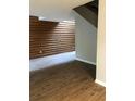 Living room with hardwood flooring, a wood paneled wall and an open floor plan at 288 Heathersett Sw Dr, Marietta, GA 30064