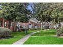 Brick building exteriors, lush landscaping, and walkways in a quiet community at 4282 Roswell Ne Rd # G2, Atlanta, GA 30342