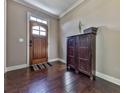 Bright entryway with hardwood floors, a wooden door, and a dark brown cabinet at 217 Towering Peaks, Canton, GA 30114