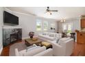 Living room featuring hardwood floors, fireplace, and access to dining area at 4367 Favored Way, Union City, GA 30291