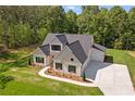 Aerial view of a home with a large driveway and a well-manicured lawn at 130 West Lake Blvd, Carrollton, GA 30116
