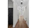 Bright hallway with wood floors, white walls, and stylish light fixtures at 130 West Lake Blvd, Carrollton, GA 30116