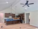 Spacious kitchen design with island, pendant lights, dark wood cabinetry, vaulted ceilings and stainless appliances at 130 West Lake Blvd, Carrollton, GA 30116