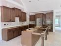 Spacious kitchen featuring wooden cabinets and a large island awaiting countertops in a well-lit interior at 130 West Lake Blvd, Carrollton, GA 30116