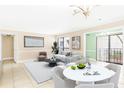 Bright living room with a dining table, neutral tones, and a sliding glass door to a balcony at 2657 Lenox Ne Rd # A-9, Atlanta, GA 30324
