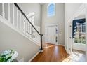 Light-filled foyer features hardwood floors, high ceilings, and a staircase at 4130 Summit Gate Dr, Suwanee, GA 30024
